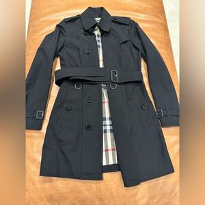 Burberry London women’s trench coat size 2 color black with check lining.